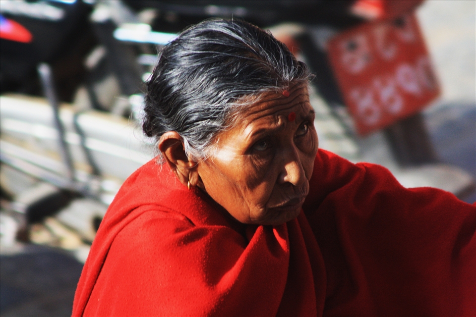 The lines on an old lady's face are evidence of a hard life of poverty