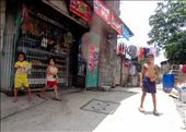 Children are everywhere in the streets here.  All of them are full of life, inquisitive, and curious of my white face.: by powellesk, Views[323]