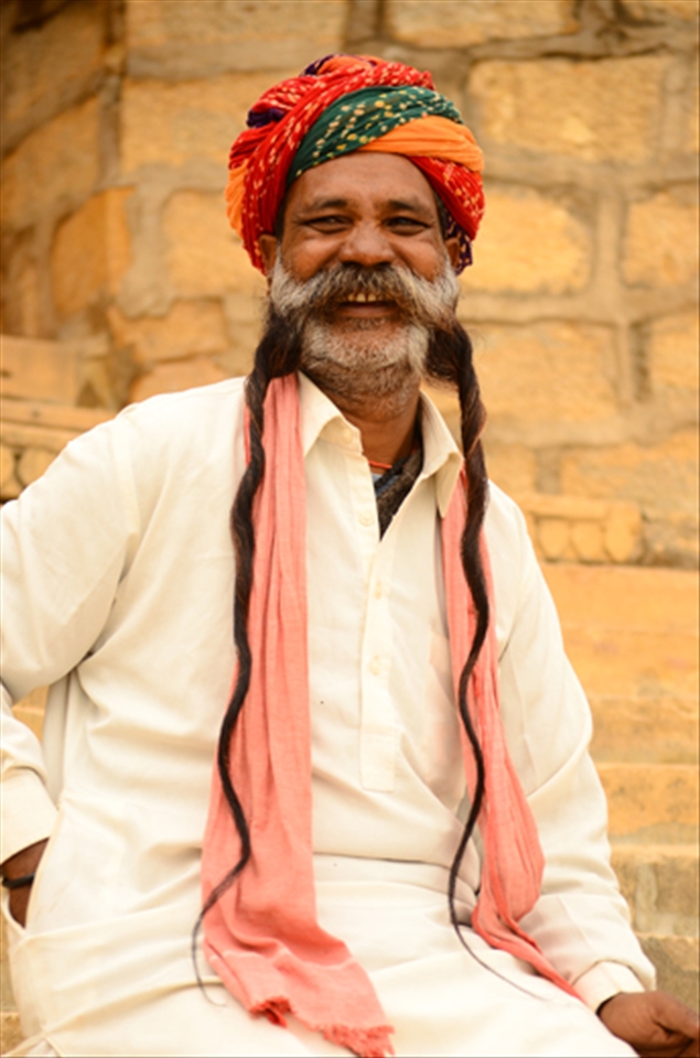 A long beard man sitting and laughing while I was capturing him. 