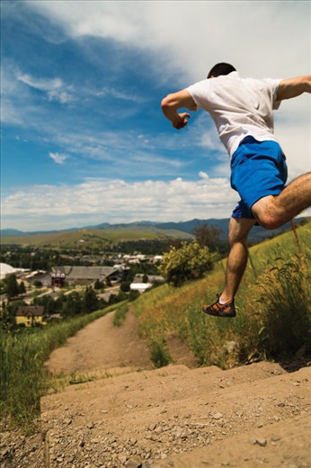 (1) One of the greatest characteristics of Missoula, MT is that, no matter who you are, you are never out of place there.  “Zootown”, as it is affectionately called, is not so unlike a zoo with regards of the colorful personalities and wide diversity of people you may find.  The major difference being that no one is caged in Missoula, and there is a lot of cage-free living to be done.  Almost a part of the sky himself, the runner in this photo barrels down the slope of the popular “M-trail” adjacent to the University of Montana Campus.  Fitness and freedom are a significant part of the culture in Missoula.