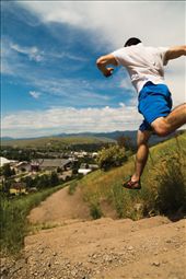 (1) One of the greatest characteristics of Missoula, MT is that, no matter who you are, you are never out of place there.  “Zootown”, as it is affectionately called, is not so unlike a zoo with regards of the colorful personalities and wide diversity of people you may find.  The major difference being that no one is caged in Missoula, and there is a lot of cage-free living to be done.  Almost a part of the sky himself, the runner in this photo barrels down the slope of the popular “M-trail” adjacent to the University of Montana Campus.  Fitness and freedom are a significant part of the culture in Missoula.: by prhutchi, Views[755]