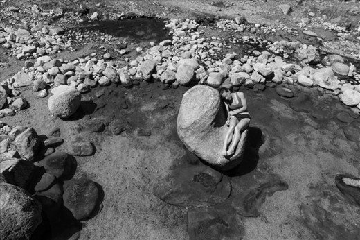(3) Exploration and wonder abound both in the city and outside its limits. Only a short drive out of town, hot springs serve as both a social mecca and a secluded getaway.  Just a few springs over, a gregarious group converses while this woman found quiet company with the sun and geothermal water. Clothing is, of course, optional.