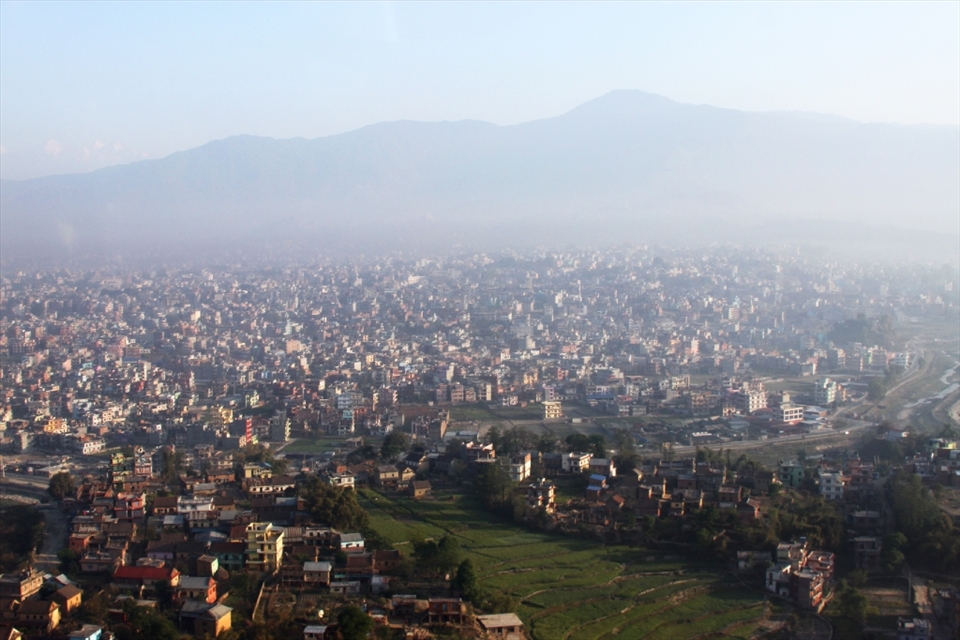 The morning mist rises over Kathmandu en route to Lukla to begin the trek.