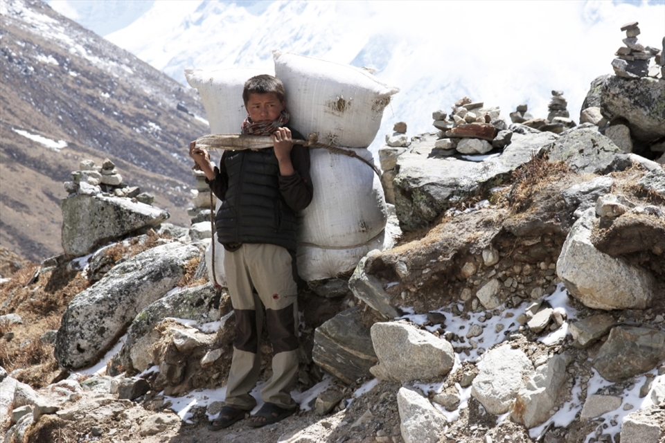 A fledgling porter, probably carrying around 100kg on his head.