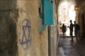 There is a sense of history and importance on every corner in the Old  City of Jerusalem. There are religious symbols and paraphernalia in front of you at every, each side staking a claim. This picture is of a star of David drawn with chalk on a wall in an alley in the Old City. I focused on the star and left the people in the background as blurred silhouettes, to symbolise how in this country, and this city in particular, religion is considered more important than people.: by pryan, Views[275]