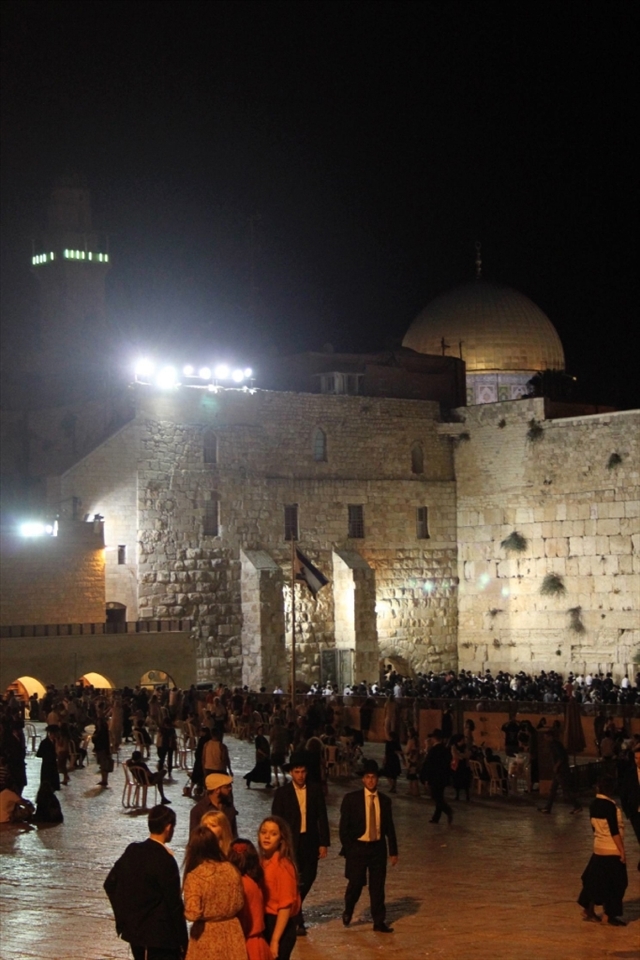 The eternal divide. 
The wall is a sacred place for Jews but even here it is impossible to ignore the great Muslim interest in this city. As night falls and both Jews and tourists visit, the Dome on the Rock  stands proudly beyond the wailing wall.