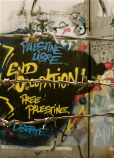 The seperation wall built around Bethlehem and other Palestinian areas of the West Bank is a source of annoyance and pain for residents of these areas. A walk around the wall is an opportunity to see some beautiful pro-Palestine graffiti. This photograph was taken of some of this graffiti on the seperation wall and I incorporated a nearby barbed wire fence into the picture to symbolise the feelings of imprisonment being expressed in the graffiti.