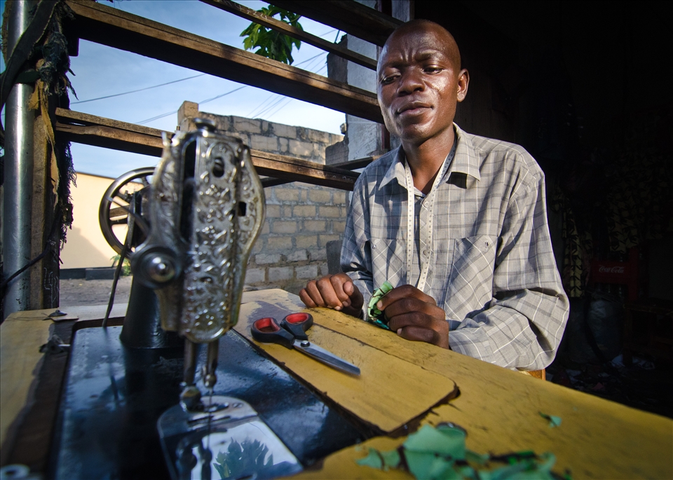 The market in Mongu town is usually so busy you can barely move. However this was taken during the Kuomboka Ceremony where the King arrives at his dry season palace. The market was completely empty except for this man making dresses for a friends wedding.
