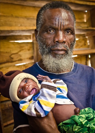 This man was in his final year of studying medicine before he had to leave his home in Angola because of the civil war. Despite having finished the training and exams he was never officially qualified. He and his wife now run a village for orphans. The baby girl in the photo and her twin sister were only 4 days old when this was taken. Their father died of AIDS and their mother died during childbirth.