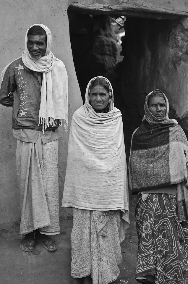 Kishan, who runs a small cycle repair shop, smiles with his wife and sister in front of his dilapidated house. He has no money to repair his house. He never went to school; today he barely earns enough to feed his family. 