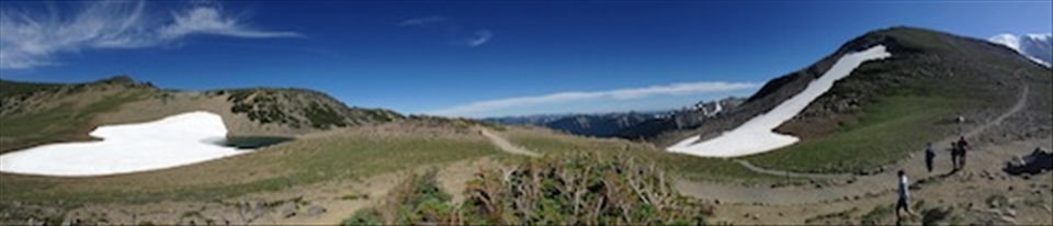 Hiking away, we stopped to take in how far we had gone. The sky was open and blue and hills decorated with snow pack. Still a while to go
