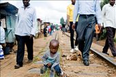 boy is sitting on the railtrack in Kibera. the old railtrack is still in service: by qdeleeuw, Views[484]