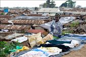 woman is selling clothes, surrounded by garbage. On backgrond Kibera village: by qdeleeuw, Views[652]