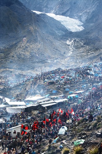 Thousands of pilgrims, organized by parades and Inca nations, climb the mountain at over 15,500 feet, dancing and singing with unusual energy. At CuZco, Peru.	
	