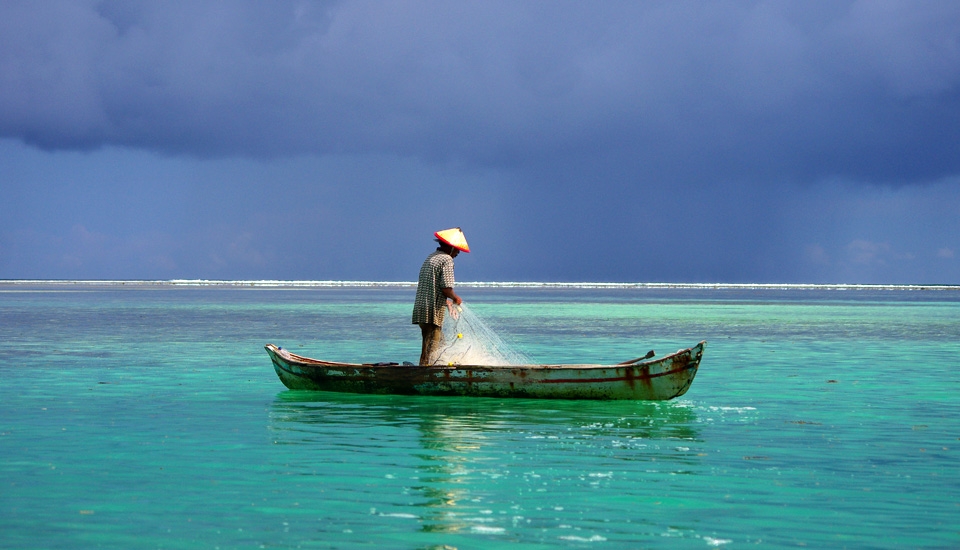 The primary Industry in Telo is fishing. In fact, it is not exactly an industry here, it is primary survival. The seasonal squalls are about to induce this man to pick up his oar, and dig his way home.