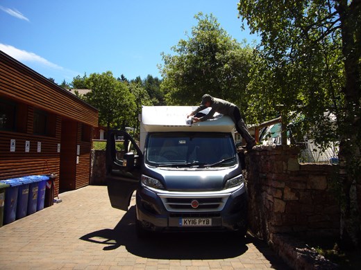 Applying 130 metres of gaffer tape to the hole in the roof of the van (with temperatures in the late thirties, all the clothing is to keep the sun off me)