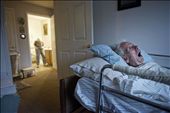 Roger lies in bed as Eleanor washes clothes in the bathroom. Eleanor didn't want to put Roger in a nursing home or be away from him. She felt it was important for her to take care of him to the best of her abilities.: by rachelwoolf, Views[873]
