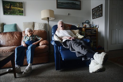 Eleanor glances over at Roger as he sleeps.