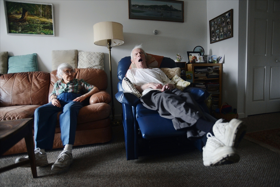 Eleanor glances over at Roger as he sleeps.