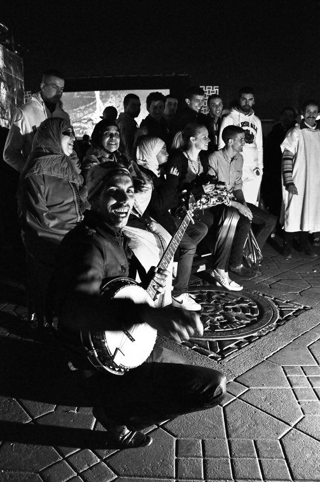 Music show of local people on Jamma-el-Fna, Marrakech, December 2012 - For this square is typical – how says one a famous Spanish poet  Juan Goytisolo – „The spectacle of Jamaa el Fna is repeated daily and each day it is different. Everything changes — voices, sounds, gestures, the public which sees, listens, smells, tastes, touches.“ I can not describe it better. Local musical artists for a few minutes convince you that this moment is the only one and you want  to spend your time right here, listening to their kind of folk music.