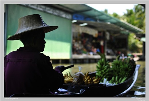 A vendor selling fruits on a floating market in Damnoen Saduak, Thailand 