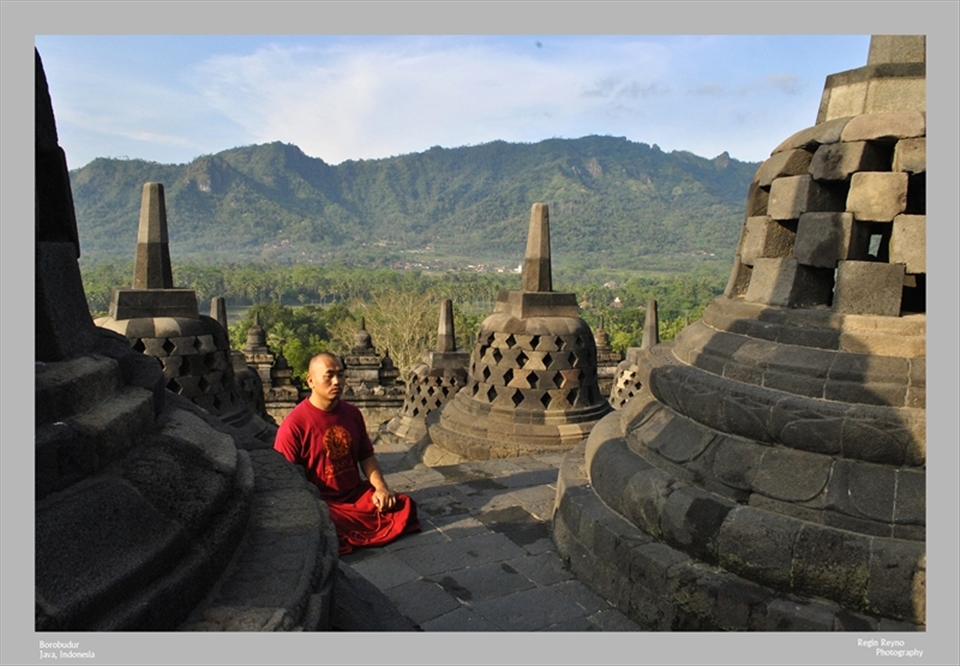 A Buddhist monk meditating in Borobudur temple, Central Java.