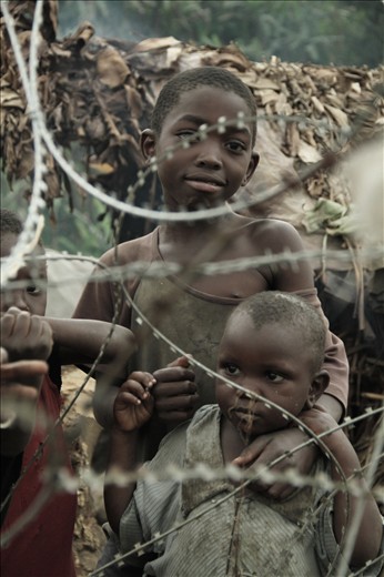 Glance between wire. Kids of the village always curious with the news visitors.