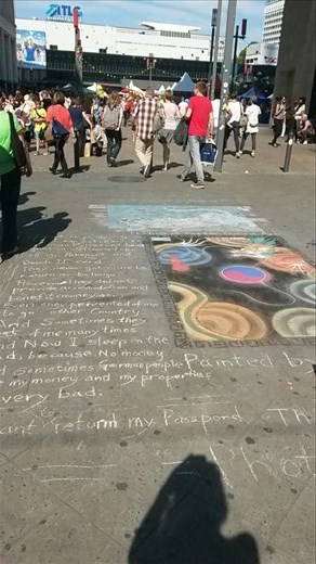 This street chalk was next to E.T.. People were just not paying him any attention and were walking through it. I don't know if you can read it but the artist was just stating his situation and asking for help.  We gave him some money.
