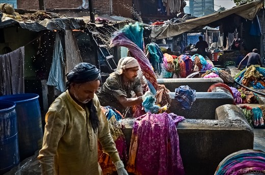 The washing is vigorous work. Several generations work alongside each other.