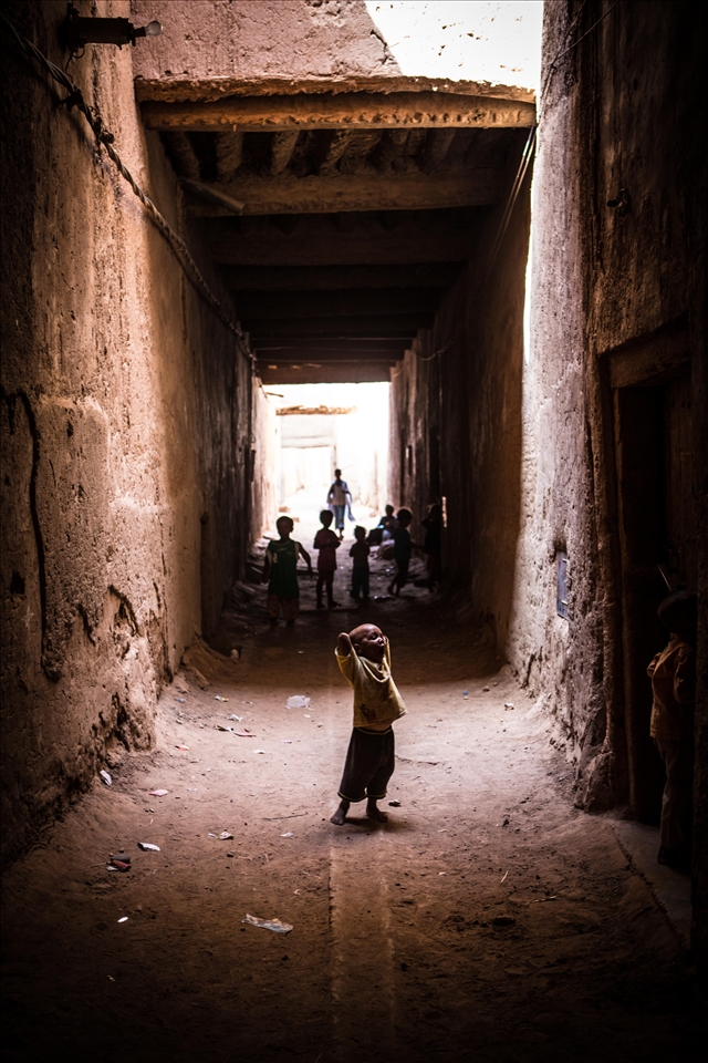 Kids playing in the mud tunnels to hide from the sun