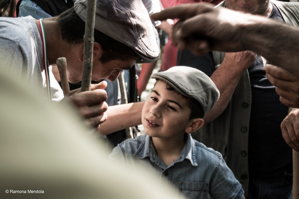 An herdsman caresses his son during the rite.