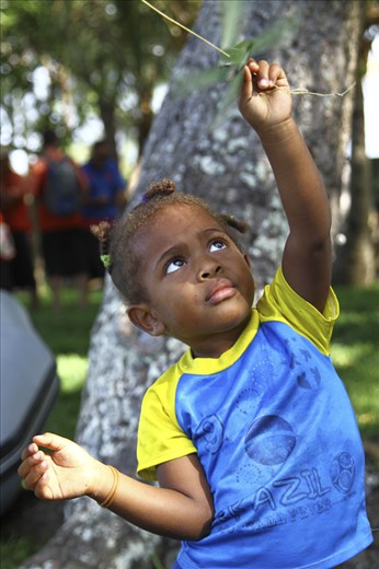 Future of the Pacific:

A young girl plays with a wind spinner made for her by one of the pacific voyagers standing in the background. She represents the future of the pacific, the future that Te Mana o Te Moana sailed across the pacific for, raising awareness and inspiring action to protect and care for our oceans.
