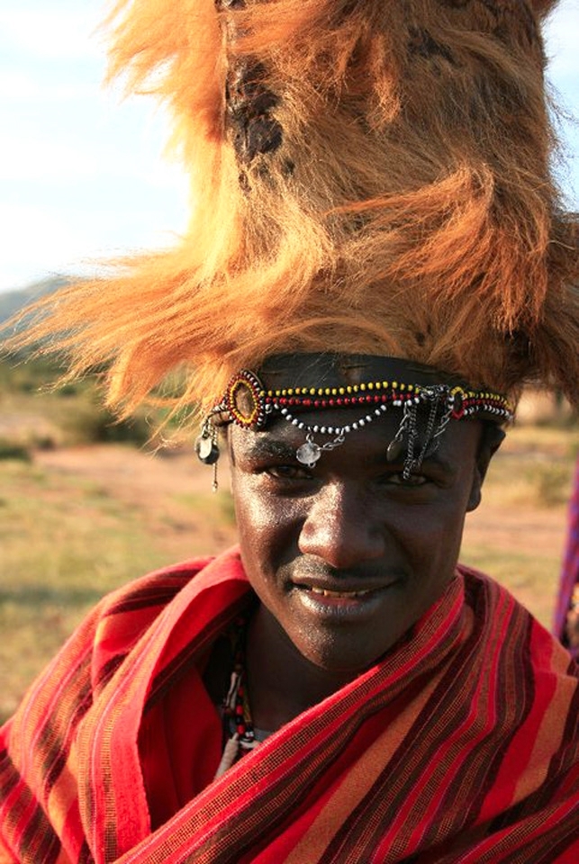Solomon:
​​
To become a man in the Masaai tribes of Tanzania and Kenya you must kill a lion and bring back it's mane, this then makes you eligible for circumcision and marriage. The man in the photo is Solomon who is wearing a momento of his kill. He was preparing himself for the ceremony later that evening.