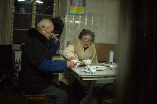 Grandparents eating dinner at home