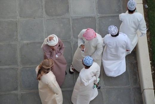 This moment was captured at Sultan Qaboos University in Muscat, Oman. I commonly would walk on the elevated paths to get from place to place, which is expected as a women, while the men walked on the ground. I stopped for a moment and looked over the edge to see these university students mingling while two others passed by. They are dressed in traditional Omani garb known as a 'dishdasha'. I presume these men come from a moderate/high socioeconomic class due to there head scarfs, material of their dress, and phones. To attend this institution you have to be in the top percent of your class, so these men I presume went to a good private school in Oman. As you can tell all of my assumptions of these men are just that, assumptions, as a women and being half Omani in my traditional abaya, I may never known the answers to those questions or hear the stories of their lives. 