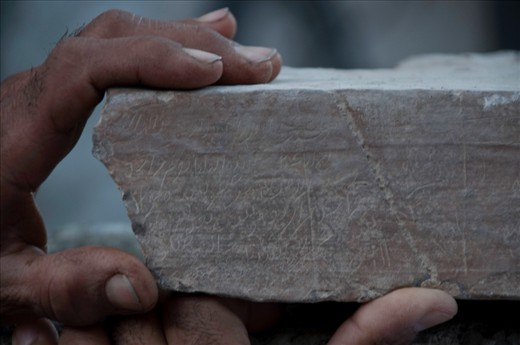 Two generations – one born well before the oil wealth transformed the country and one born into it – reverently hold an inscribed stone from the old mosque while telling the story of a famous Imam who prayed in the original mosque over 450 years ago while en route to recruit fighters against Portuguese rule over coastal Oman.