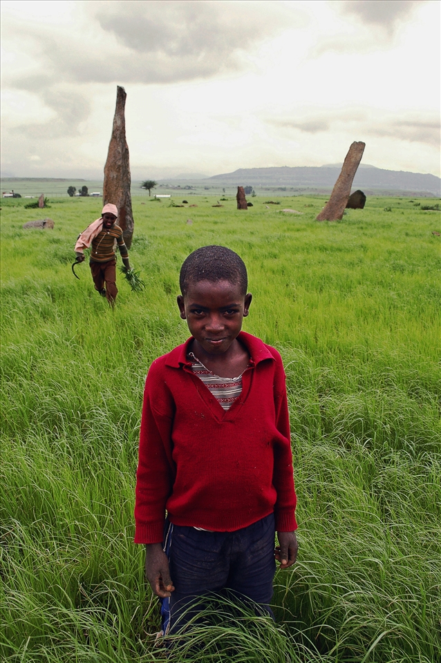 Children work and play among ancient aksumite stelae, Ethiopia