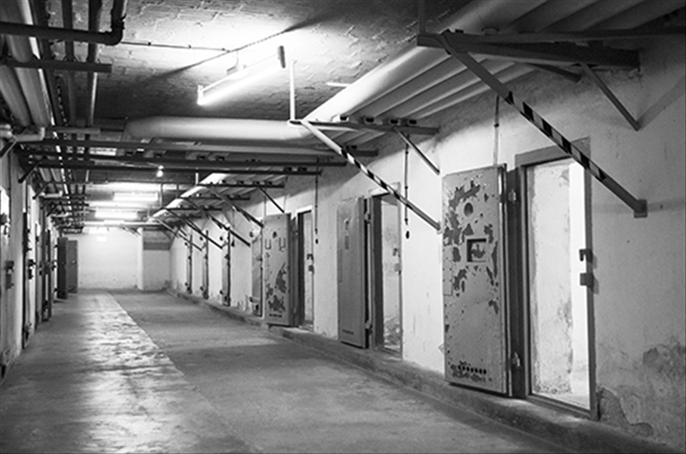 Genslerstrasse, Berlin. Tucked away in a leafy Berlin suburb lies an unassuming compound surrounded by guard towers and barbed wire. Formerly an infamous Stasi prison, it is now home to the Berlin- Hohenschönhausen Memorial. 
Stepping through the heavy metal door into one of the cellblocks, the air is cold and damp, and the bright afternoon sunshine outside seems to have been consumed by a much darker world. This particular block was nicknamed the “submarine”, as it is underground and does not get much natural light. 