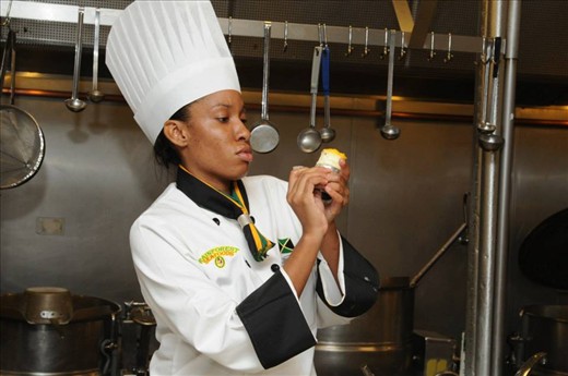 Process of putting the Jerked Peanuts on the Ackee & Scotch Bonnett Cheesecake