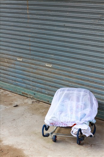 During a boat ride just south of Luang Prabang, we stopped in at a small village along the banks of the Mekong River. The people here made their living brewing potent whisky and selling odd trinkets to passing tourists. We had arrived during a special time – the village had all come together in the tradition of building funeral constructs for the elderly. I felt particularly out of place and a little intrusive strolling through the village while they peeled, nailed, bent and tied the vessel that would house their relatives into death. While the men where fashioning the coffin material out of plants and wood, the women were in the houses clipping wet money onto clotheslines and preparing lunch. During the commotion, something struck me as peculiar. It rang in my mind like a distasteful joke. While the soon-to-be dead were being attentively looked after, in the quiet corners of the town sat the very young. Alone.