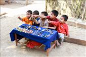 After our boat ride along the Mekong River, we happen to cross a small village not far from the banks of the water. The majority of the occupants were fishing while the kids played in the shallows of the river amongst the pyrite sand. Sitting outside their huts were several locals performing odd tasks like tending to the animals, weaving tapestries to sell in the Luang Prabang markets, or carrying wood from their forages. As we turned a corner, we were greeted by a group of infants selling bracelets and trinkets. They all called harmoniously “Sa-bai-dee!” “Hello!” “Sa-bai-dee!” We all glanced at each other, silently sharing the desperation of the scene together. No one bought a thing and I still wonder if I should have.: by rhysacker, Views[794]