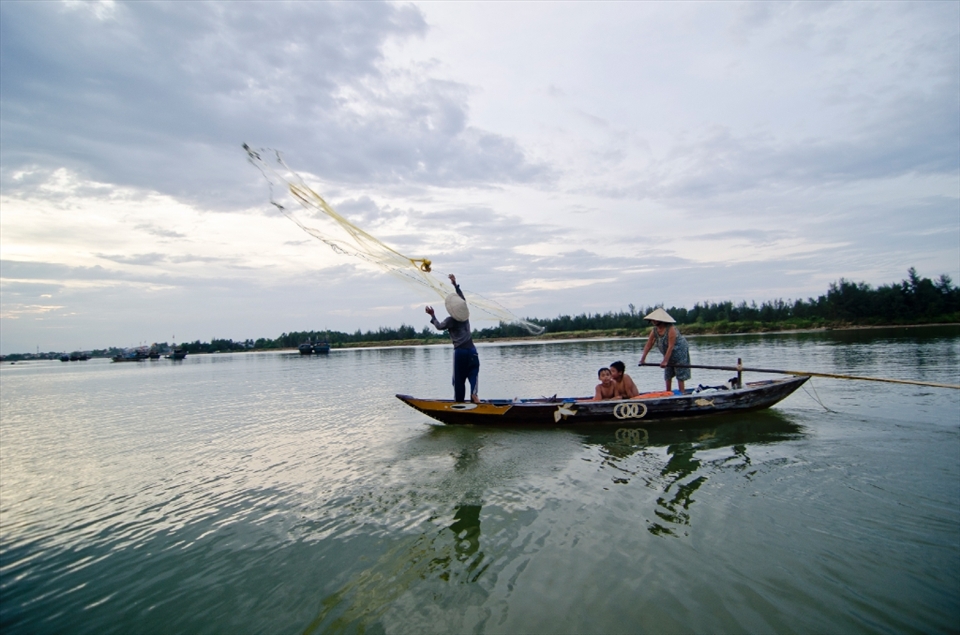 In Vietnam, fishing techniques are ancient. While some lower nets on the shores, most of the fishermen go out in their boats and throw the nets themselves. Here a fishermen and his family try to catch some fish to sell at the market.