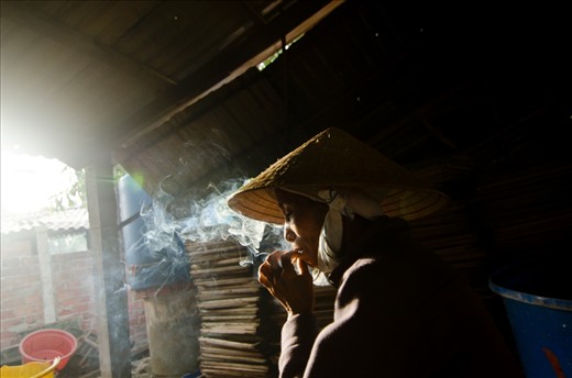 It is hard work, and every small break they have is priceless. Here a female worker smokes her cigarette while she rests from the hard work.