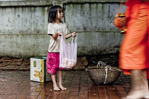 Child, who down the streets at 5.00 am, asking for small offerings to the monks