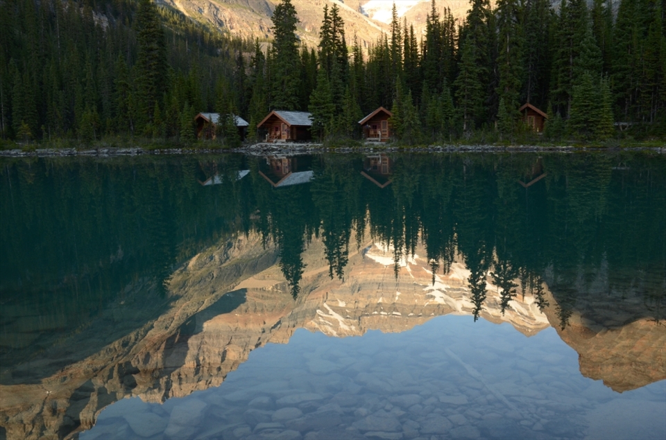 Lake O'Hara is a historical destination in the Canadian Rockies.  The Lake O'Hara logde and it's cabins are an iconic image settled on the edge of the lake in a mountain vallege. Showing the mountains in the forground, reflection, clear water and cabins gives the true sense of the setting.