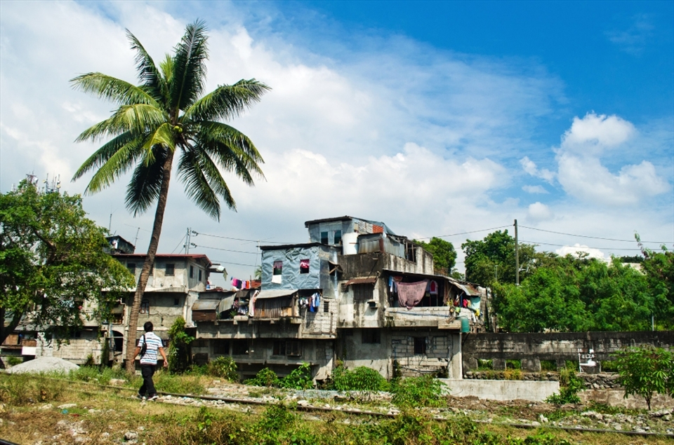 A typical day scene amongst a community of urban poor people along the railroad track of Philippine National Railways (PNR). This location in Taguig City is just one example of  hundreds of thousand population of squatters left occupying vacant lots off the railways. Such communities are commonly known in Metro Manila as the “Home Along Da Riles” or Home along the Rails.