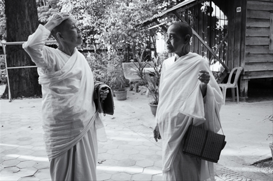 Dressed in their prayer robes, two Buddhist nuns had a brief conversation before entering a temple inside the monastery. 

This was the time when I was already starting to establish relationships with the nuns. The nuns already knew of my presence in their community and even with the language barrier they have been nothing but kind and gentle about my presence. I had been striking conversations with them thanks to my tuktuk driver who acted as my translator.

When I saw this photo while file organizing, it eventually became my 