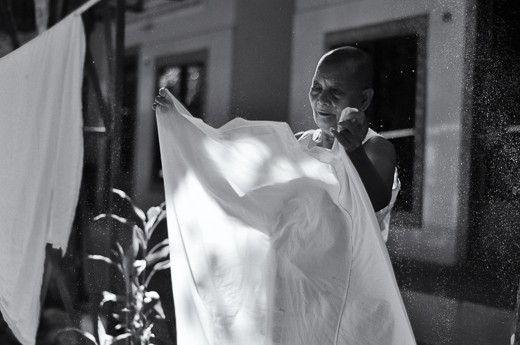As you may have noticed by now, I am easily attracted to beautiful light and have the tendency to play with it to capture emotion. When I saw the nun hanging her prayer robe out to dry, I knew it would be a lovely portrait.