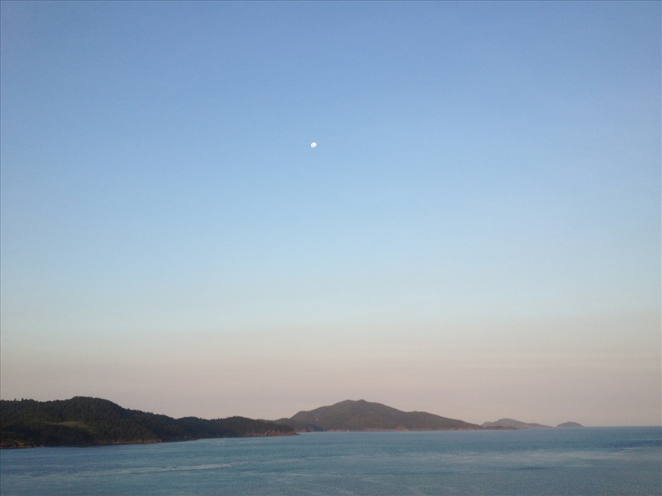 Just a beautiful shot of ocean, coloured sky and islands.