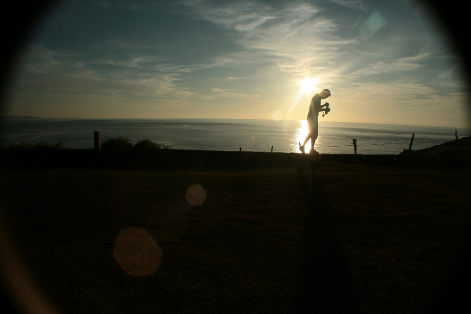 A photographer is silhouetted during a sightseeing trip in Batanes, the smallest and northernmost island province in the Philippines